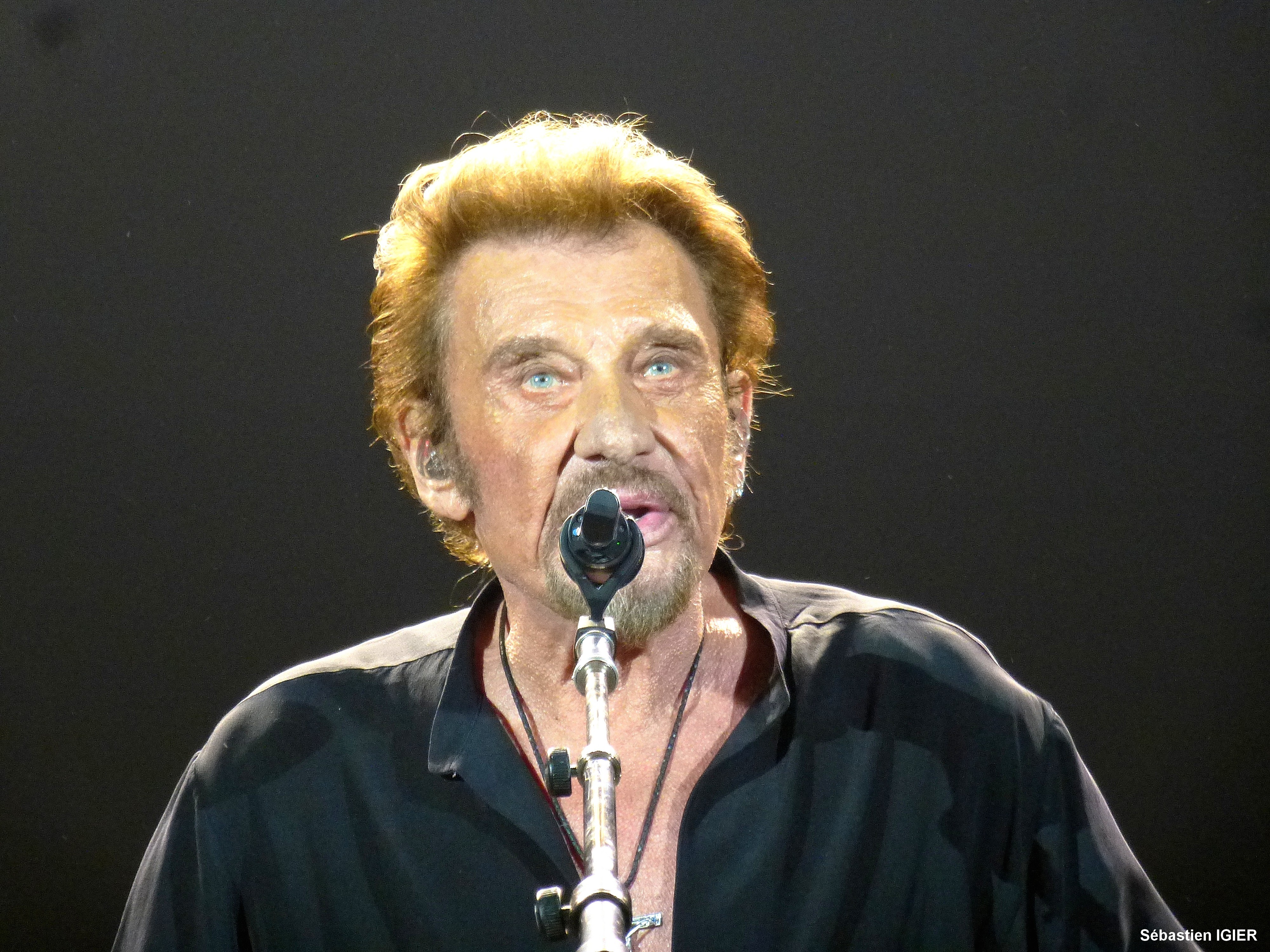 Johnny Hallyday chantant au micro sur scène en 2016